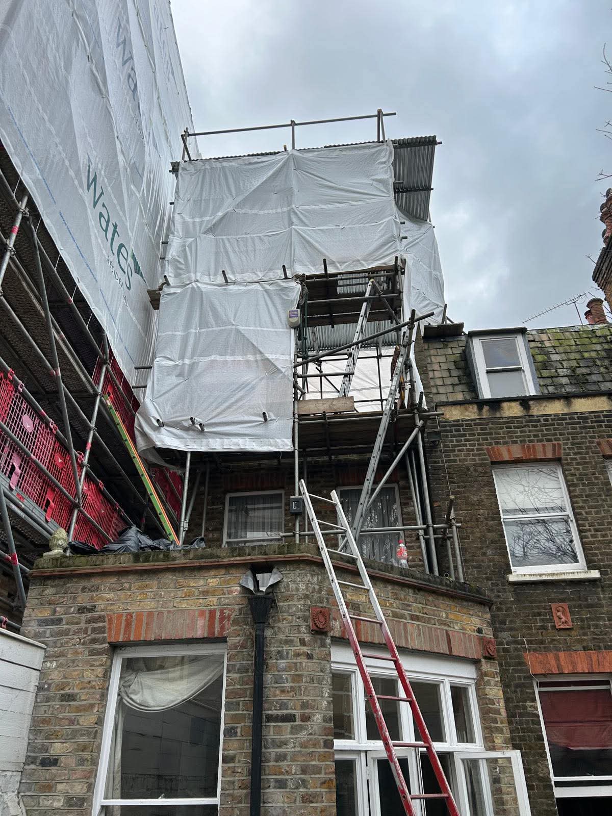 Sheeted scaffold and temporary roof to the rear of a Victorian property